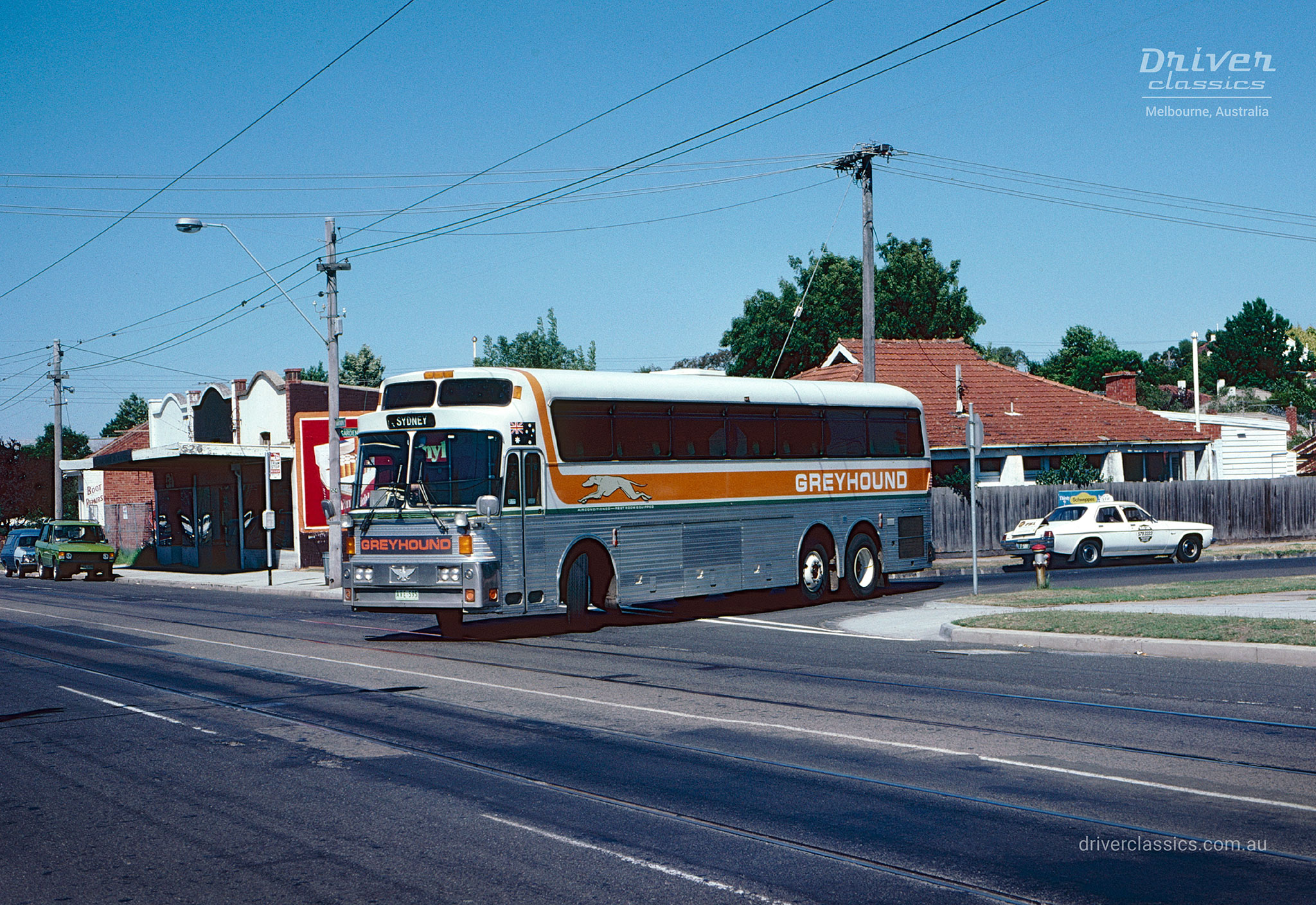 Greyhound 1976 Silver Eagle Model 05 bus, driving on road, Caulfield South VIC, Photo taken April 1981.