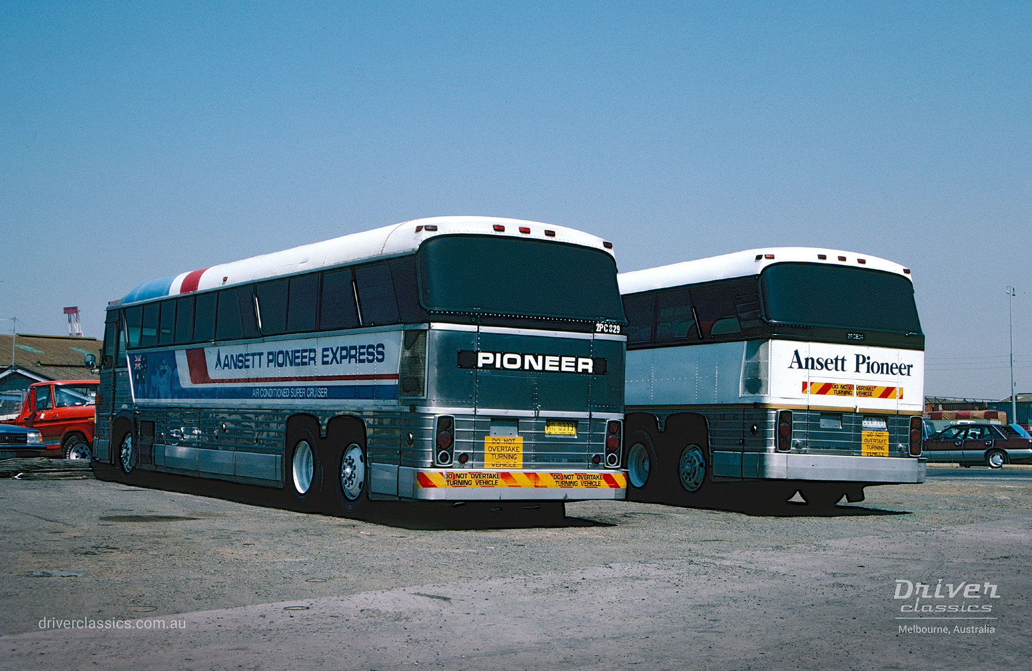 MCI MC8 bus with silver back and MCI MC8 with white back, both featuring Ansett Pioneer livery. Photo taken in 1987.
